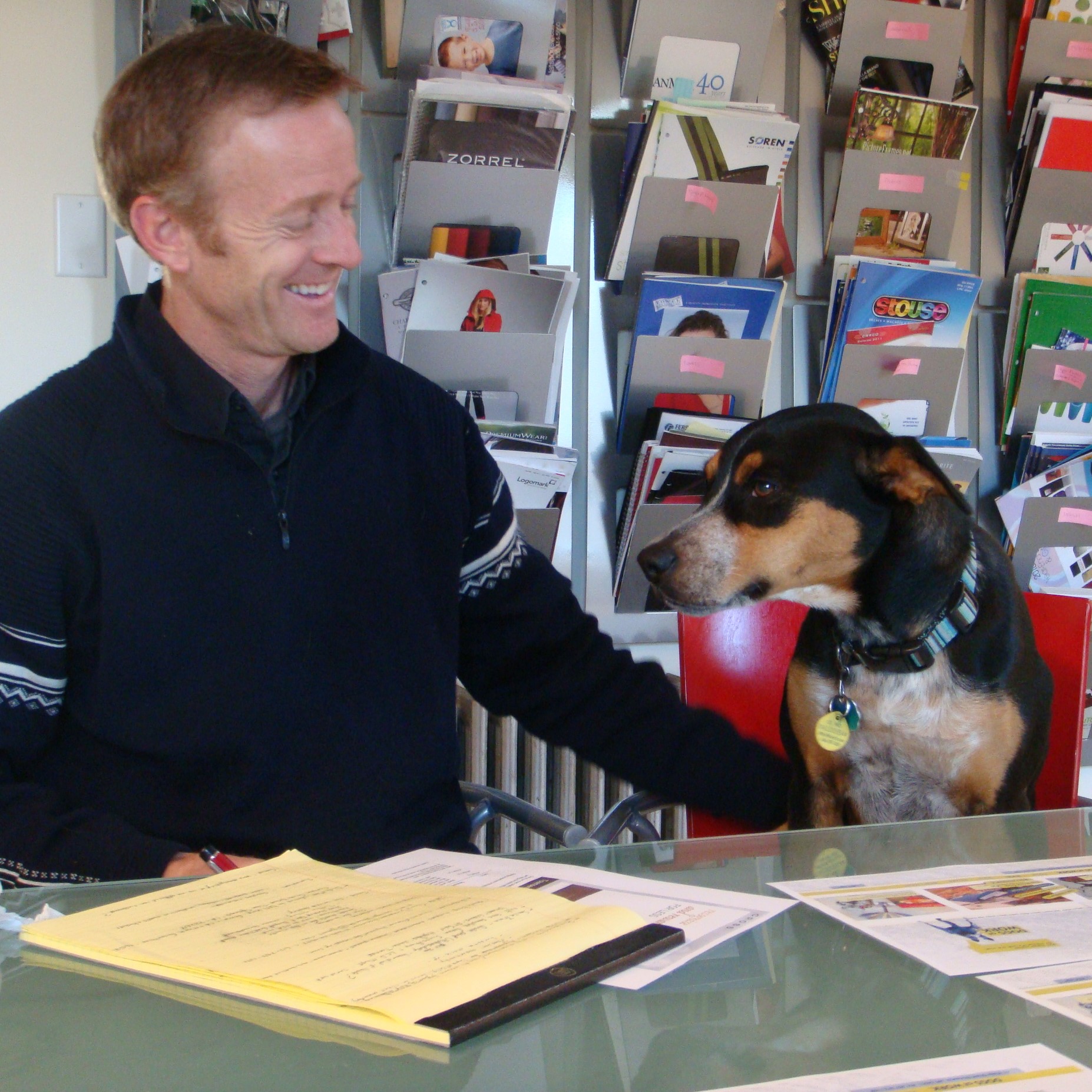 Andy and dog Ozzy at the conference table